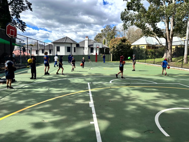 Students using our newly updated sports court for fitness and fun